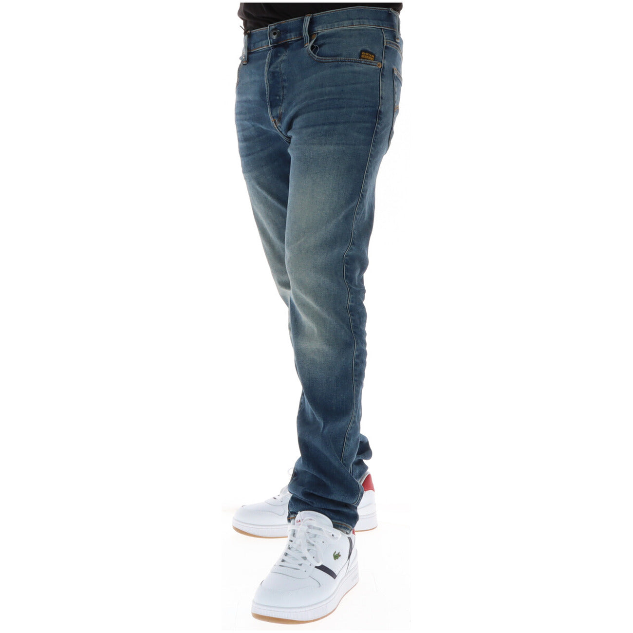 Side view of blue jeans with a faded wash and slim fit on a white background