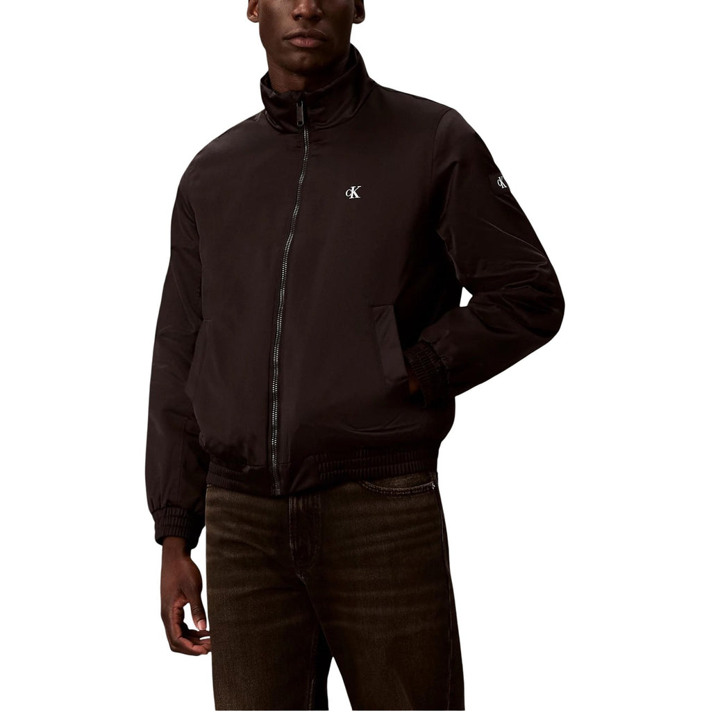 Front view of the black Calvin Klein Jeans blazer featuring a zipper closure and high collar.