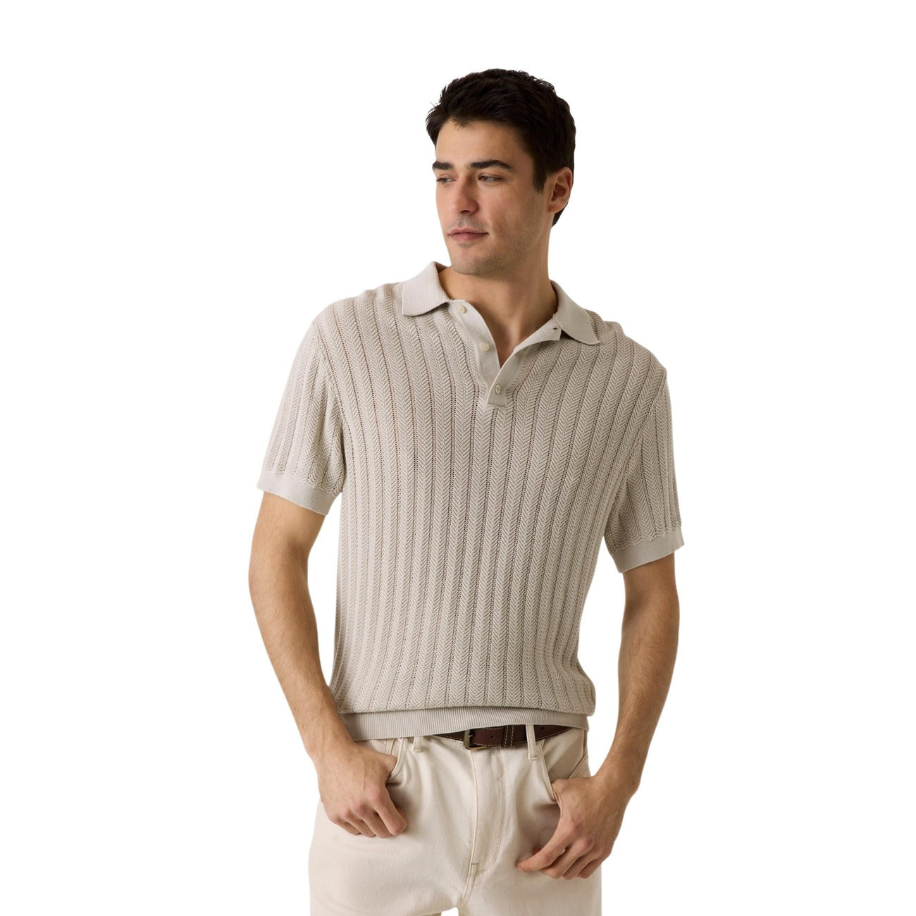 Lifestyle shot of a beige polo shirt with short sleeves and collar on a white background.