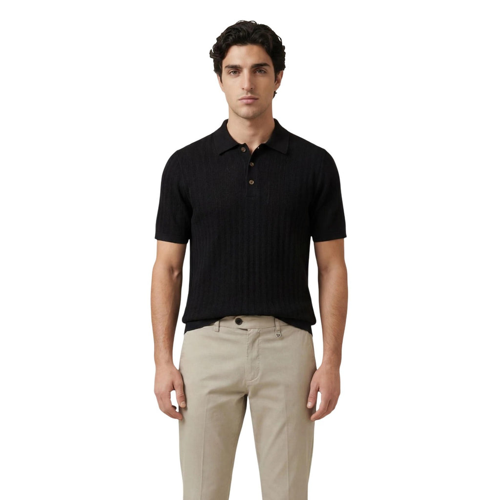 Front view of the black polo shirt featuring short sleeves and a button placket.