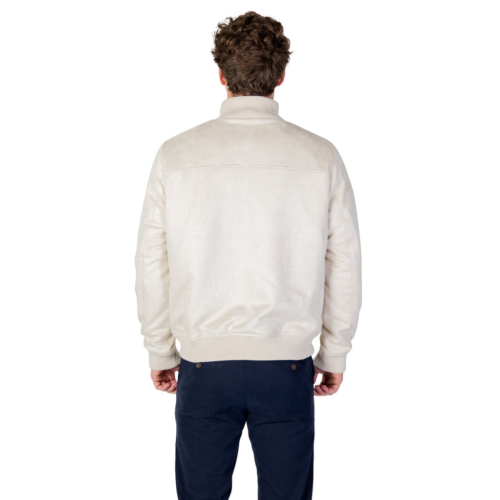 Lifestyle shot of the light beige blazer showcasing button closure and quilted design.