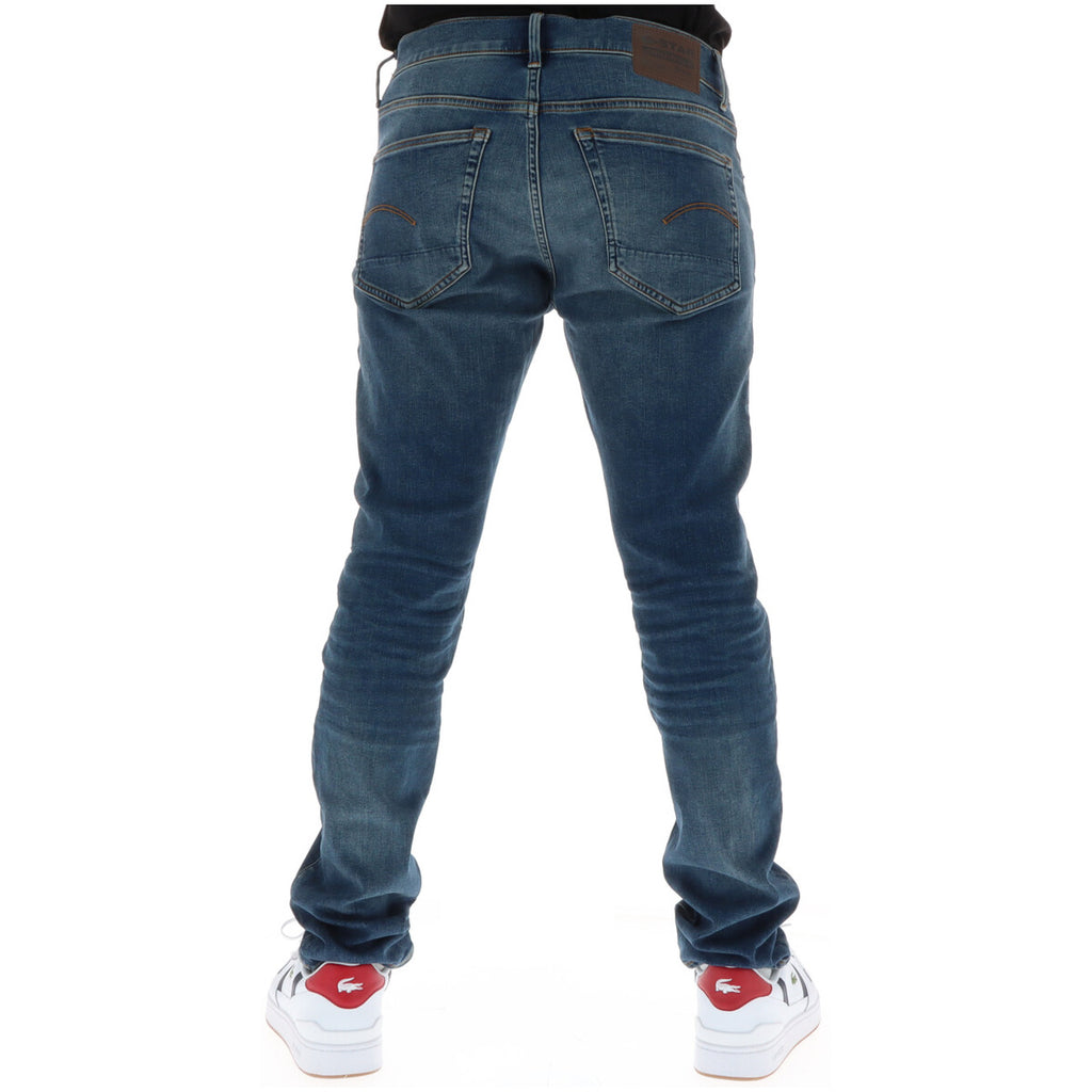Back view of blue jeans showcasing pocket details with a faded wash on a white background