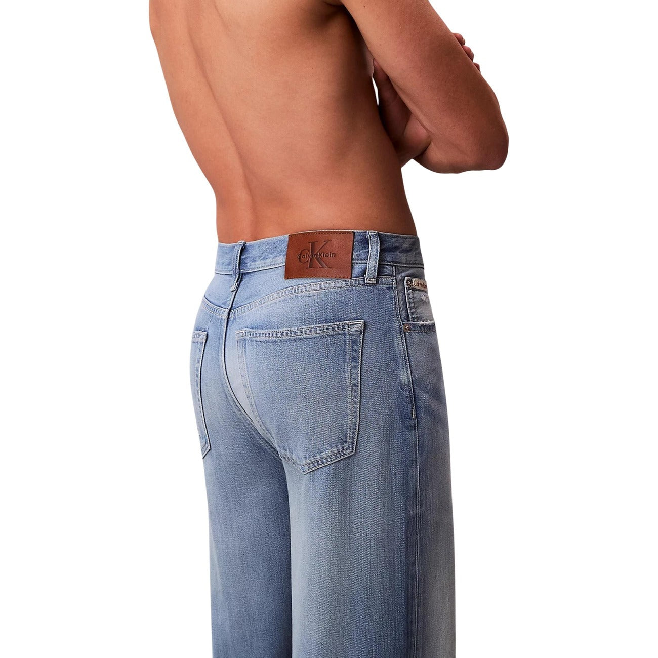 Side view of blue wide leg jeans with light wash on a white background
