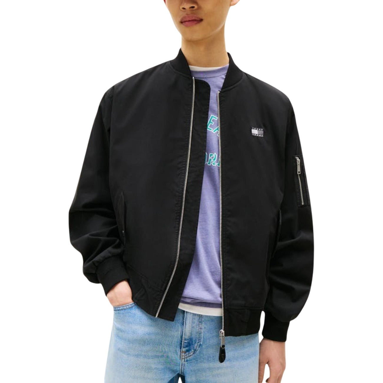 Lifestyle shot of the black bomber jacket featuring a zipper closure and logo detail against a white background.